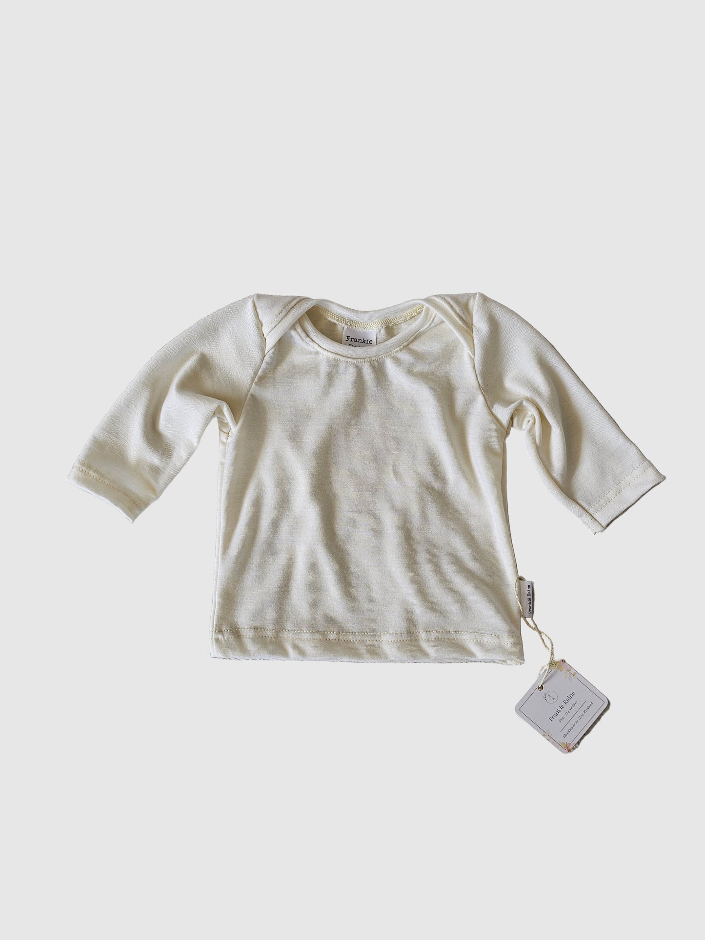 White baby long-sleeve tee.