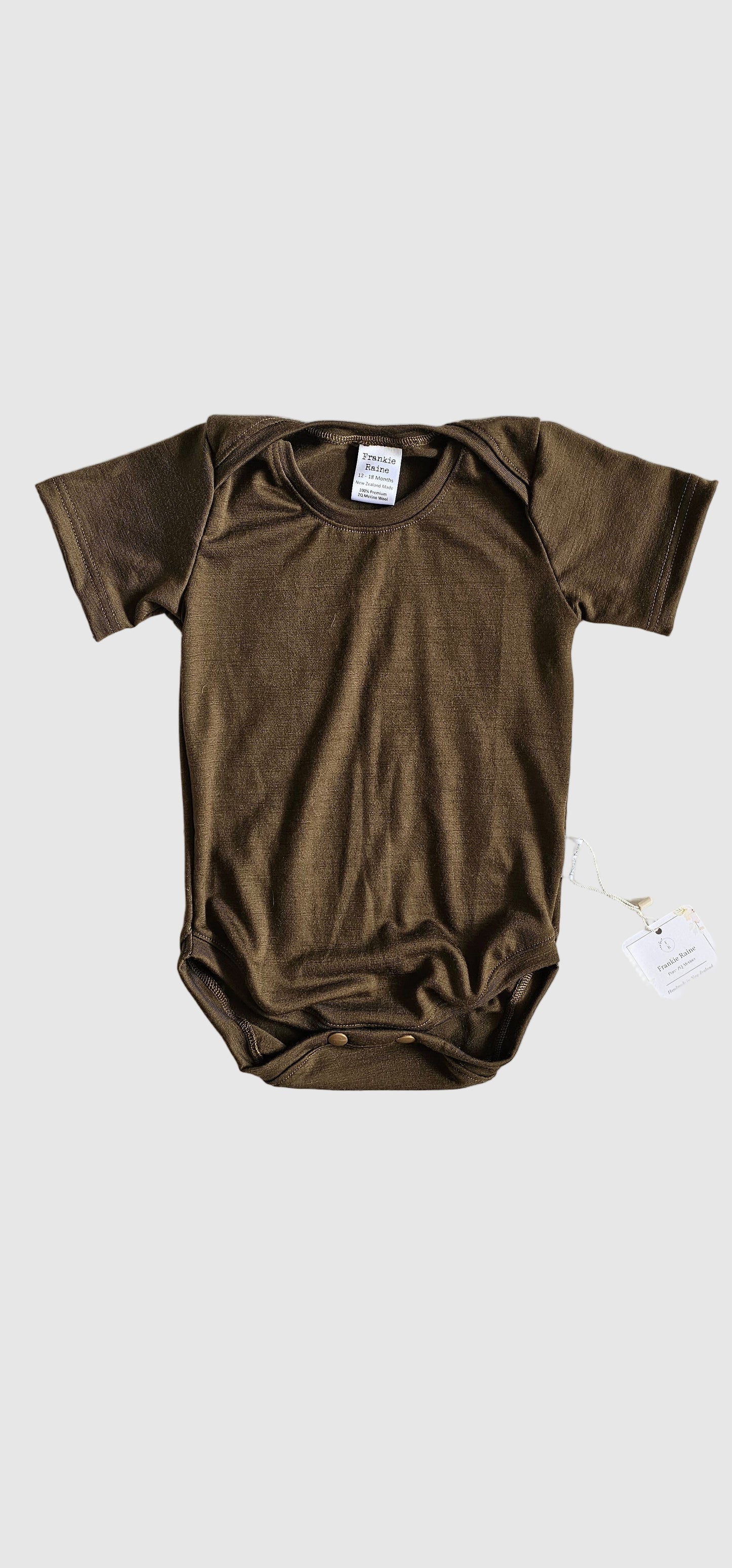 Brown long-sleeve shirt on a light gray textured surface