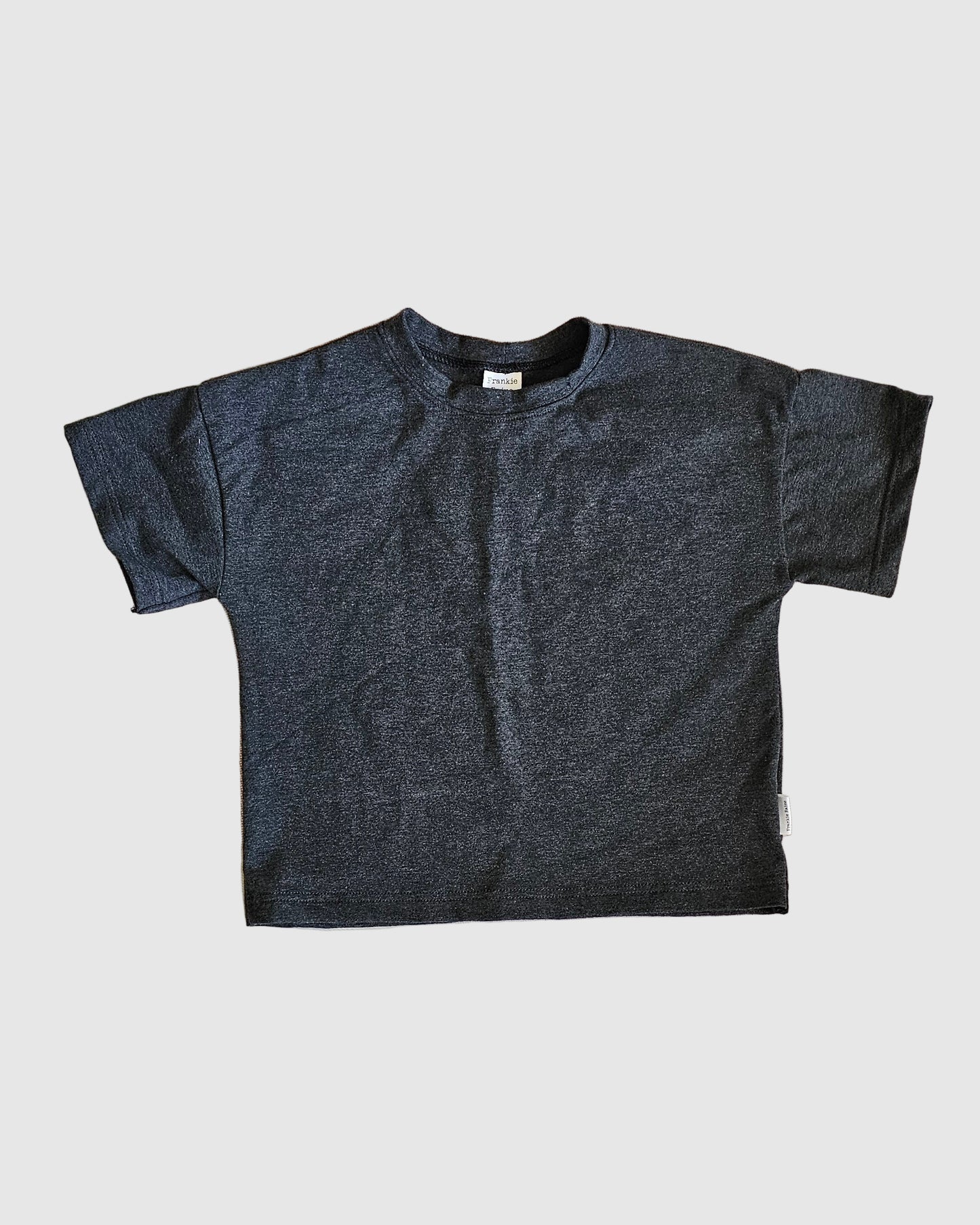 Dark gray t-shirt on a light gray background