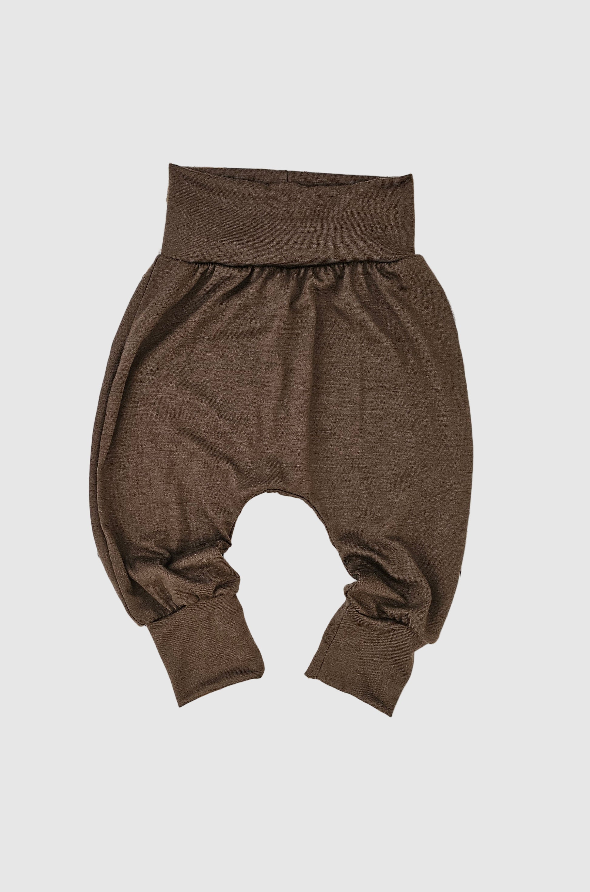 Brown harem pants on a wooden surface