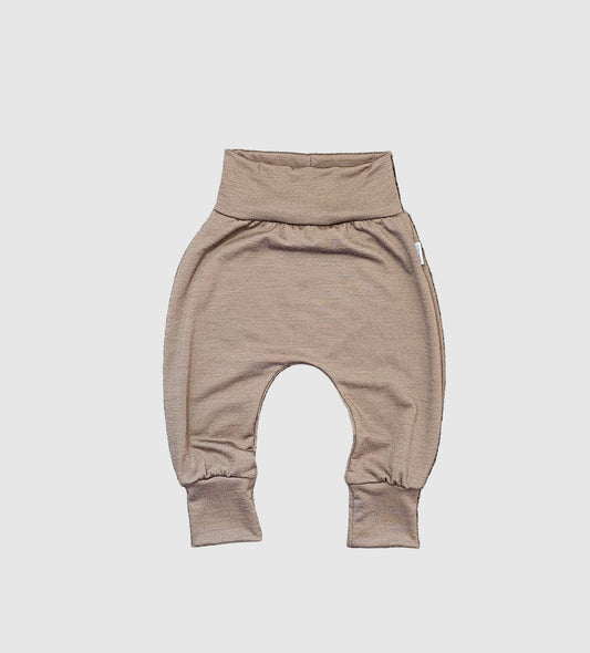 Brown baby harem pants on a gray textured surface