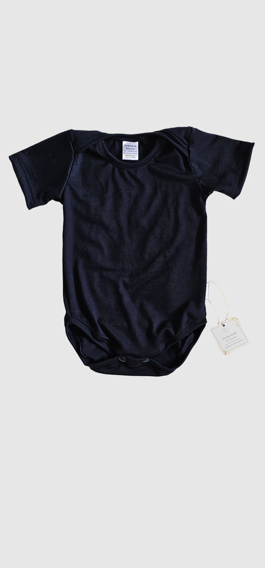 Black long-sleeve shirt on a textured white surface
