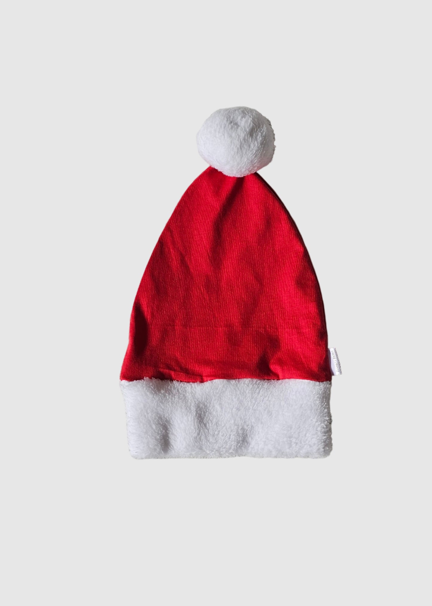 Red Santa hat on a textured gray surface