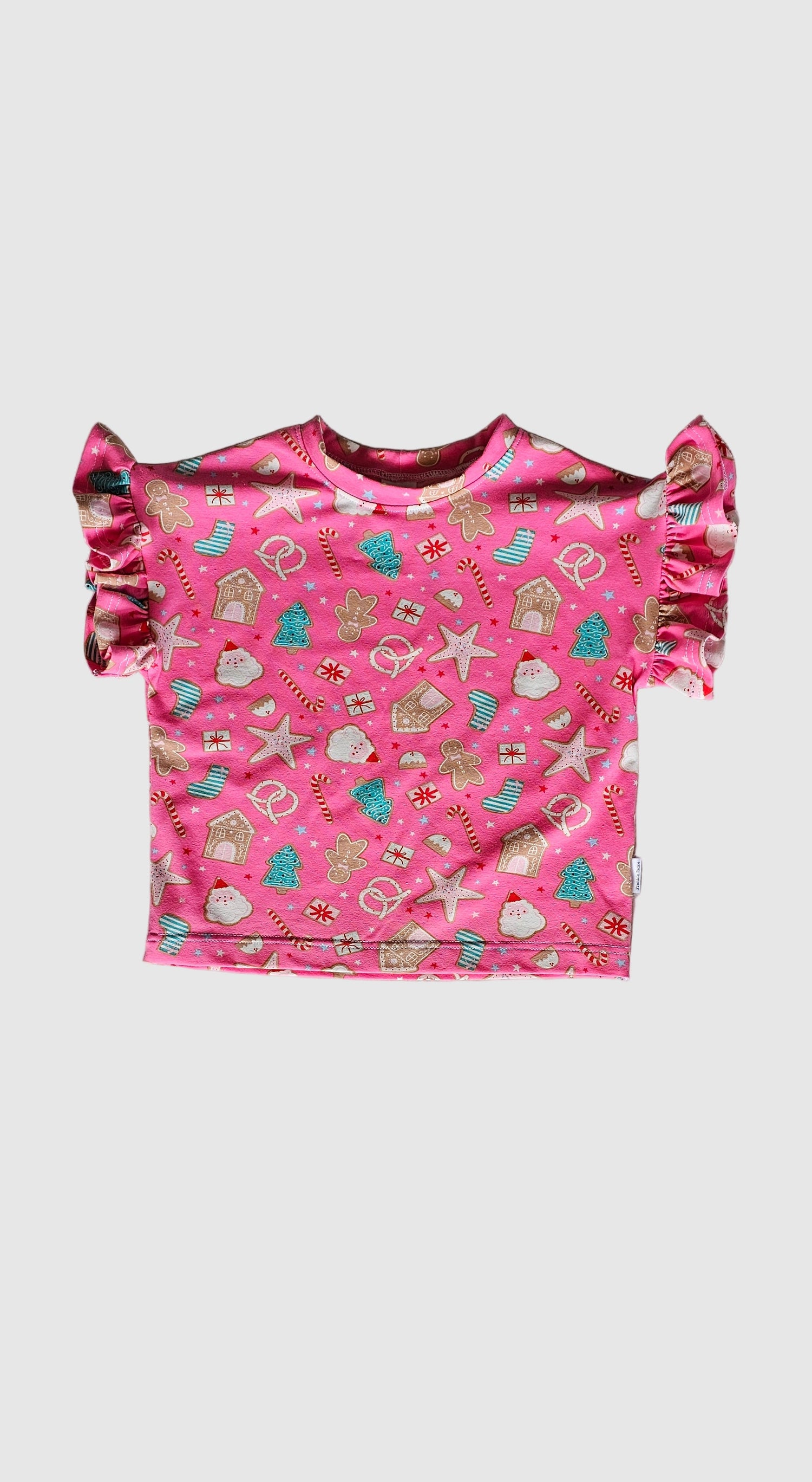 Pink children's dress with pattern on a gray surface