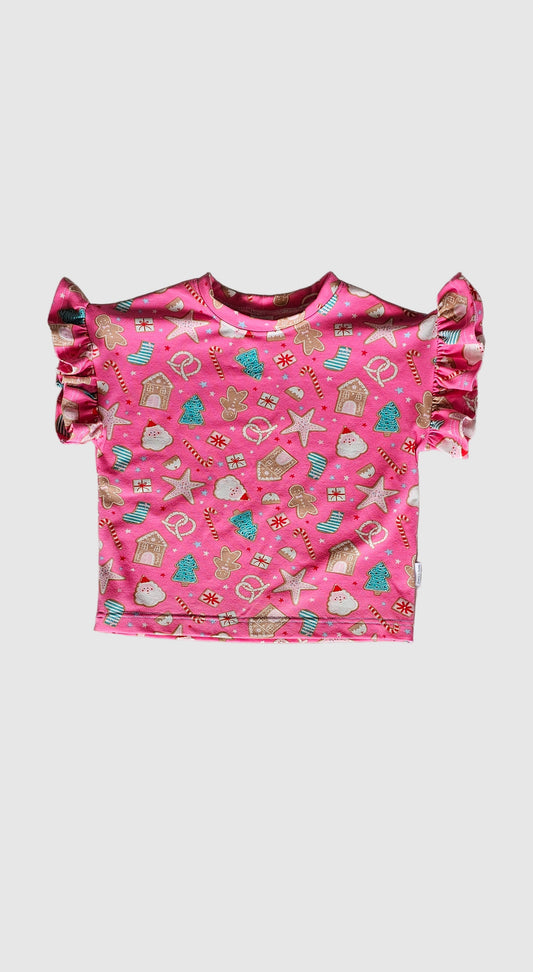 Pink children's dress with pattern on a gray surface