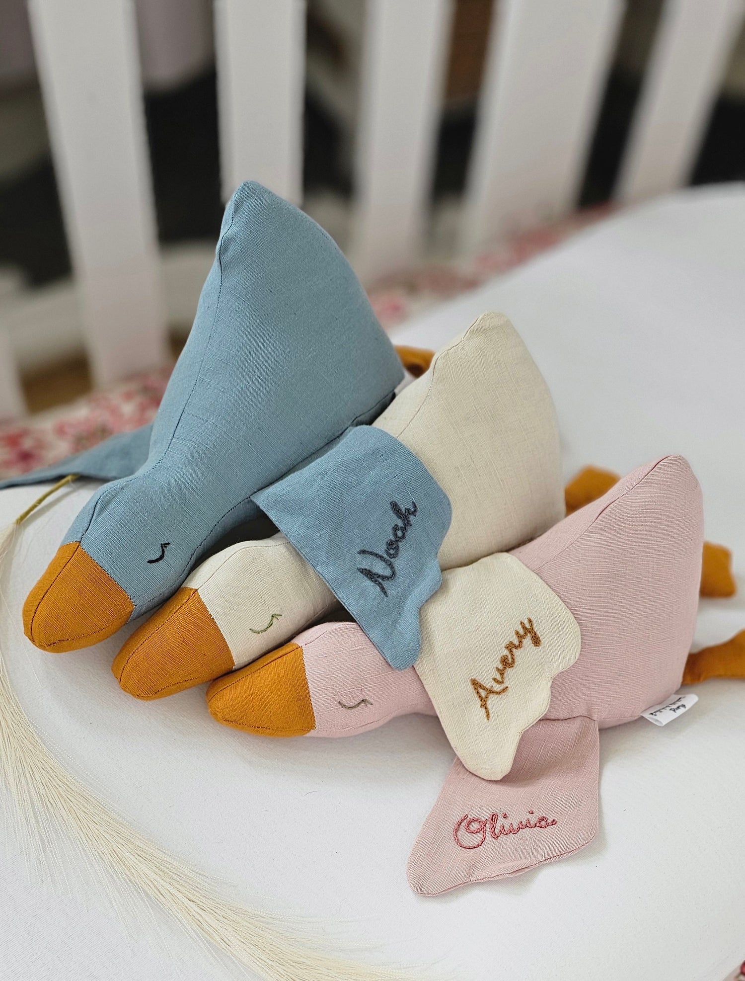 Remy the Goose soft toy in three colours, styled flat lay on white background.
